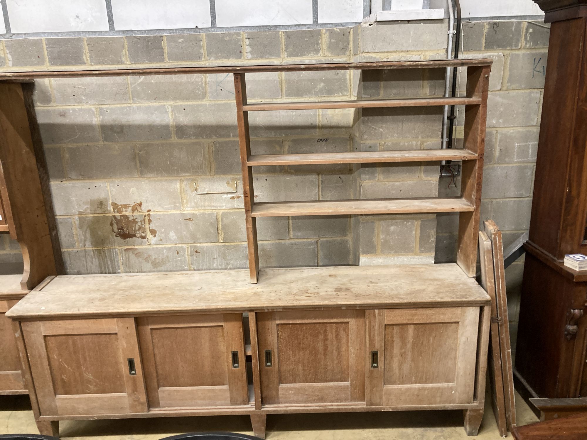 Two mid century pine and fruitwood sliding door household cupboards, larger 245cm, depth 47cm, height 204cm